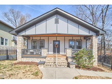 Charming craftsman-style home with stone accents, a covered porch, and a welcoming entrance at 723 Holloway St, Durham, NC 27701