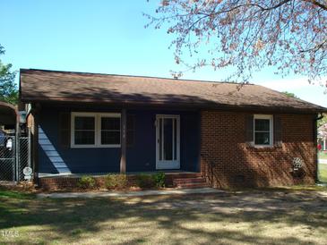 Charming single-story home featuring a brick facade and well-maintained front yard at 110 N 8Th St, Erwin, NC 28339