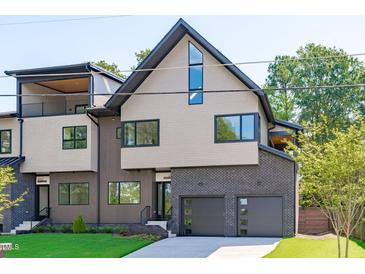 Stunning modern home showcasing unique architectural elements and a well-manicured lawn at 1406 Lyon St # 101, Raleigh, NC 27608