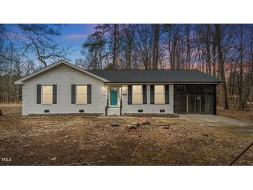 Charming single-story home featuring a white brick facade, black shutters, and an attached screened-in porch at 2232 Miller Rd, Hillsborough, NC 27278