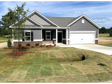 Charming single-story home with gray siding, white trim, and a well-maintained front yard at 316 Olivia Crossing Ct # 11, Four Oaks, NC 27524