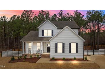 Charming two-story home with a welcoming front porch and well-manicured landscaping at 40 Long Needle Ct, Youngsville, NC 27596
