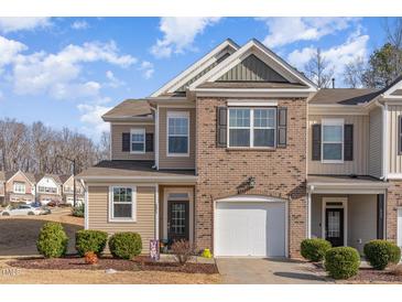 Charming two-story townhome with brick and siding, attached garage and well-manicured landscaping at 501 Historic Dr, Hillsborough, NC 27278