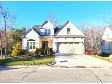 Charming two-story home with well-manicured lawn and a two car garage on a sunny day at 98102 Drummond, Chapel Hill, NC 27517