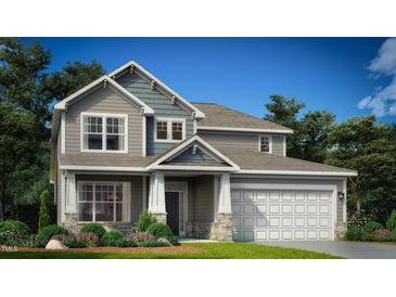 Charming two-story home boasts a landscaped yard and a two-car garage for convenient parking at 142 Sugar Pine Drive, Franklinton, NC 27525