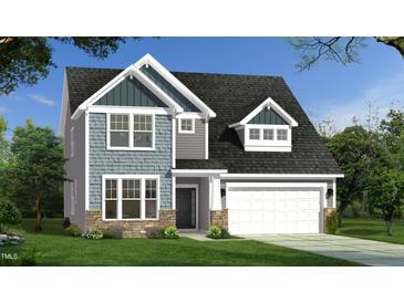 Charming two-story home featuring a stone foundation, stylish siding, a two-car garage, and a well-manicured lawn at 143 Sugar Pine Drive, Franklinton, NC 27525