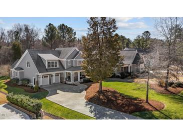 Beautiful two-story home with a charming covered front porch and manicured lawn at 818 Cabin Creek, Pittsboro, NC 27312