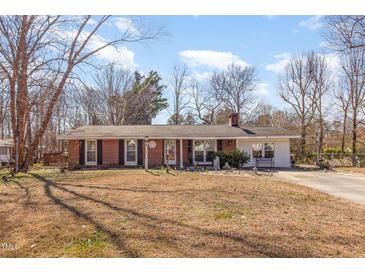 Charming single-story brick home with a well-manicured front yard at 114 Evelyn Dr, Knightdale, NC 27545