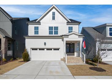 Beautiful two-story home featuring an attached garage, manicured lawn, and stylish architectural details at 140 Big Barn Dr, Wendell, NC 27591