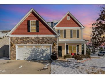 Inviting two-story home featuring a stone facade and an attached two-car garage at 4204 Vineyard Ridge Dr, Zebulon, NC 27597