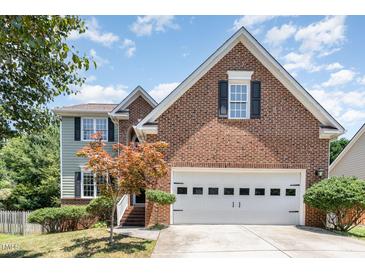 Charming two-story brick and siding home featuring a two-car garage and manicured landscaping at 5915 Eaglesfield Dr, Raleigh, NC 27613