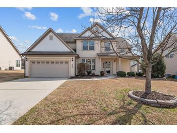 Charming two-story home boasts a well-maintained lawn, two-car garage, and inviting front porch at 714 Fairway Dr, Mebane, NC 27302
