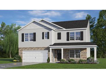 Charming two-story home with stone accents, black shutters, and a welcoming front porch at 912 Canis Minor Rd, Wendell, NC 27591
