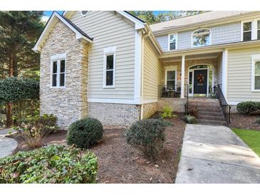 Charming home with a combination of stone and siding, plus manicured landscaping at 206 Steep Bank Dr, Cary, NC 27518