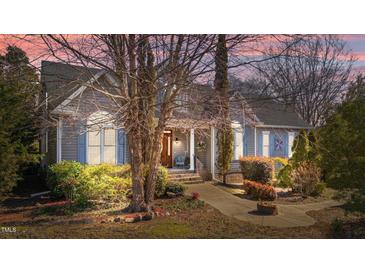 Charming home featuring a welcoming front porch, tasteful landscaping, and serene exterior lighting at 2490 Earpsboro Rd, Zebulon, NC 27597