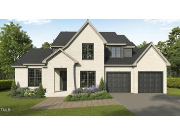 Charming two-story home featuring a brick facade, a two-car garage, and manicured landscaping at 3701 Joyful Creek Trl, Zebulon, NC 27597