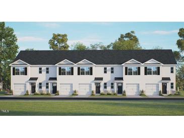New construction townhomes with a white facade, black roof, and single car garages at 428 Belgian Red Way, Wake Forest, NC 27587
