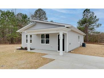 Charming home featuring a well-maintained yard and modern architectural details at 704 East St, Smithfield, NC 27577