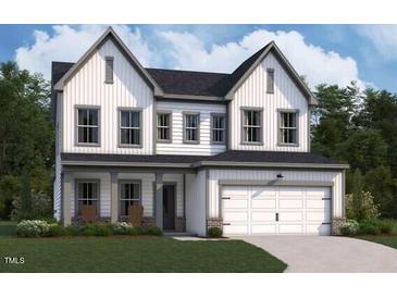 Charming two-story home with a two-car garage, symmetrical window placement, and a manicured front lawn at 121 Moonflower Ln # Homesite 258, Clayton, NC 27520