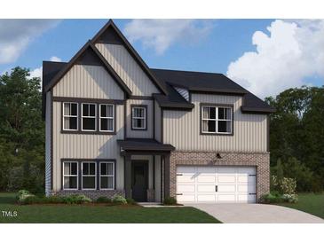 Charming two-story home featuring a two-car garage and a well-manicured lawn at 167 S Harvest Ridge Way # Homesite 223, Wilson's Mills, NC 27520