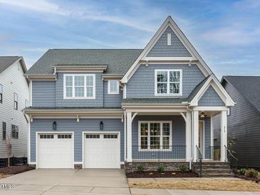 Charming two-story home with a gray exterior, white trim, and a two-car garage at 213 Big Bradley Dr, Wendell, NC 27591