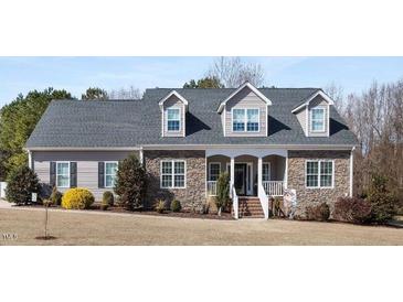 Charming single-story home featuring a stone facade, dormer windows, and a well-maintained front yard at 2570 Sweet Bay Rd, Rocky Mount, NC 27804