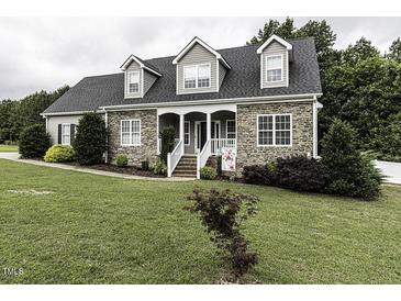 Charming two-story home with stone accents, dormers, and a welcoming front porch at 2570 Sweet Bay Rd, Rocky Mount, NC 27804