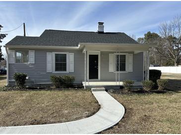 Charming home with a curved walkway, light gray siding, and a covered front porch at 4319 Denfield St, Durham, NC 27704