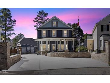 Stunning two-story home boasts inviting front porch and impeccable landscaping at 5904 River Lake Cir, Raleigh, NC 27604