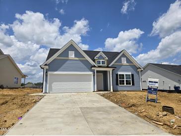 Charming single-Gathering home with a two-car garage and a well-manicured lawn at 2732 Lacy Holt Rd, Graham, NC 27253