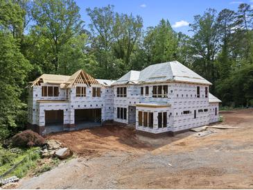 Two-story home under construction features a full unfinished basement and a charming wooded lot at 3601 Alamance Dr, Raleigh, NC 27609