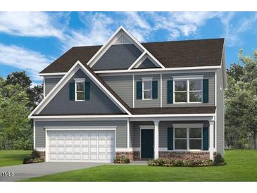 Charming two-story home with a gray exterior, garage, and landscaped front yard at 507 Olivia Crossing Ct # 20, Four Oaks, NC 27524