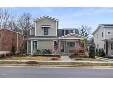 Charming two-story home with a covered front porch and professionally landscaped front yard at 917 S Blount St, Raleigh, NC 27601