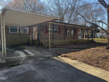 Charming brick home with a covered carport and inviting front porch, waiting for personalized touches at 922 N White St, Wake Forest, NC 27587