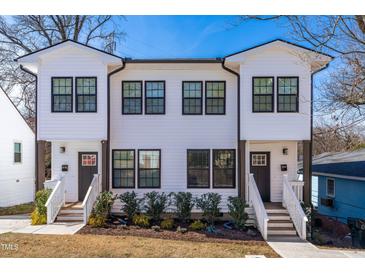 Charming townhouse featuring a white exterior, black window frames, and inviting front steps at 1211 N Guthrie Ave, Durham, NC 27703