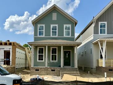 Charming two-story home with a covered porch, perfect for enjoying the outdoors at 1556 Piney Falls Dr, Wendell, NC 27591