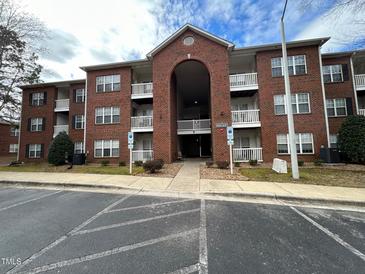 Charming brick apartment building with covered entrance and ample parking at 1647 Kenmore Dr, Clayton, NC 27520