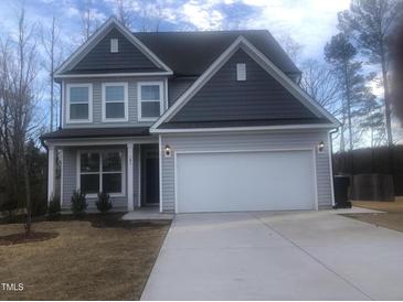 Charming two-story home with light gray siding, dark gray accents and a spacious two car garage at 185 Bourne Dr, Franklinton, NC 27525