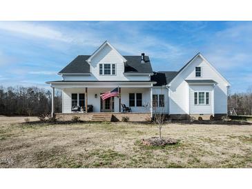Charming two-story home with a inviting front porch, American flag and well-maintained lawn at 3344 Cobb Farm Trl, Mebane, NC 27302