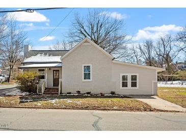 Charming single Gathering home featuring a well-manicured lawn and inviting front entrance with brick steps at 410 N Lamar St, Roxboro, NC 27573