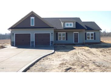 New construction home with a two-car garage, beautiful design, and spacious driveway on a sunny day at 618 Tart Town Rd, Dunn, NC 28334