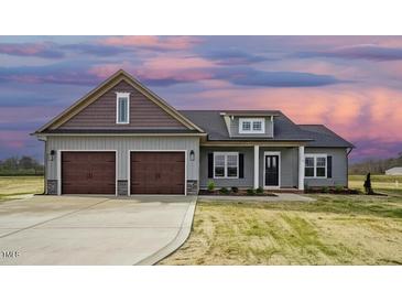 Charming new construction home featuring a two-car garage and neutral siding at 618 Tart Town Rd, Dunn, NC 28334
