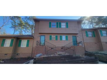 A two-story townhouse with light brown siding and green shutters is centrally located at 806 Kendall Dr, Durham, NC 27703