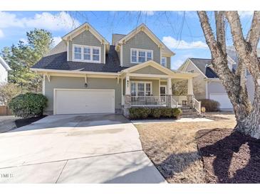 Charming two-story home with a well-manicured front yard and a two-car garage at 857 Stroud Cir, Wake Forest, NC 27587