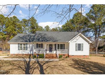Charming single-story home featuring a welcoming front porch, brick foundation, and manicured lawn at 1001 Strobus Ct, Wendell, NC 27591