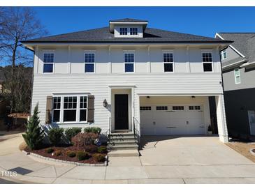 Charming two-story home features a two-car garage, manicured landscaping, and a welcoming entryway at 1317 Pecora Ln, Raleigh, NC 27607