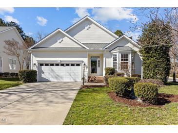 Charming single-story home with a manicured lawn, two car garage and a welcoming entrance at 200 Indian Elm Ln, Cary, NC 27519