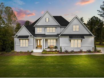 Stunning two-story home with a well-manicured lawn and a beautiful front porch at 2325 Ballywater Lea Way, Wake Forest, NC 27587