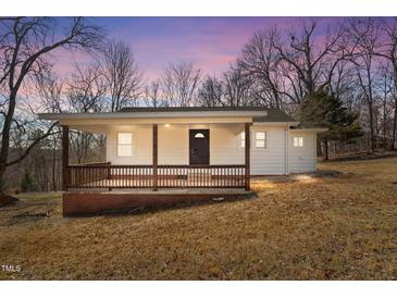 Charming single-story home with a cozy front porch and natural light at 2810 Hickory Hill Rd, Burlington, NC 27215