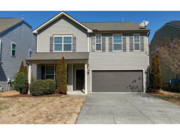 Charming two-story home with gray siding, a two-car garage, and a well-maintained front yard at 3517 Eastern Branch Rd, Raleigh, NC 27610